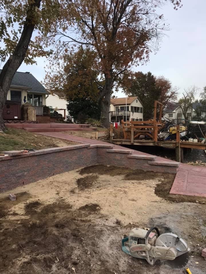 Brick retaining wall and stamped walkway at waterfront property in Maryland