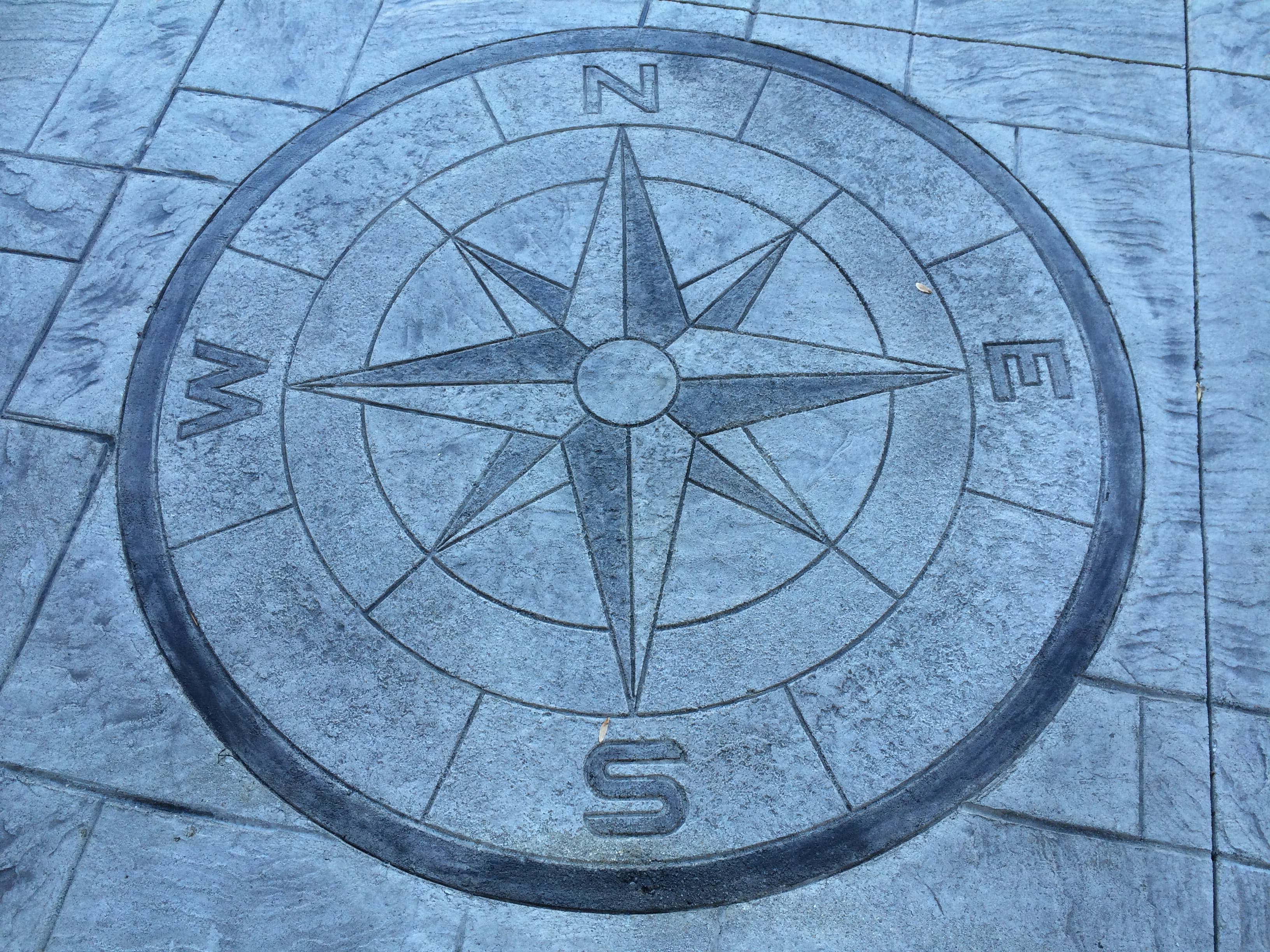 Compass rose medallion stamped concrete inlay